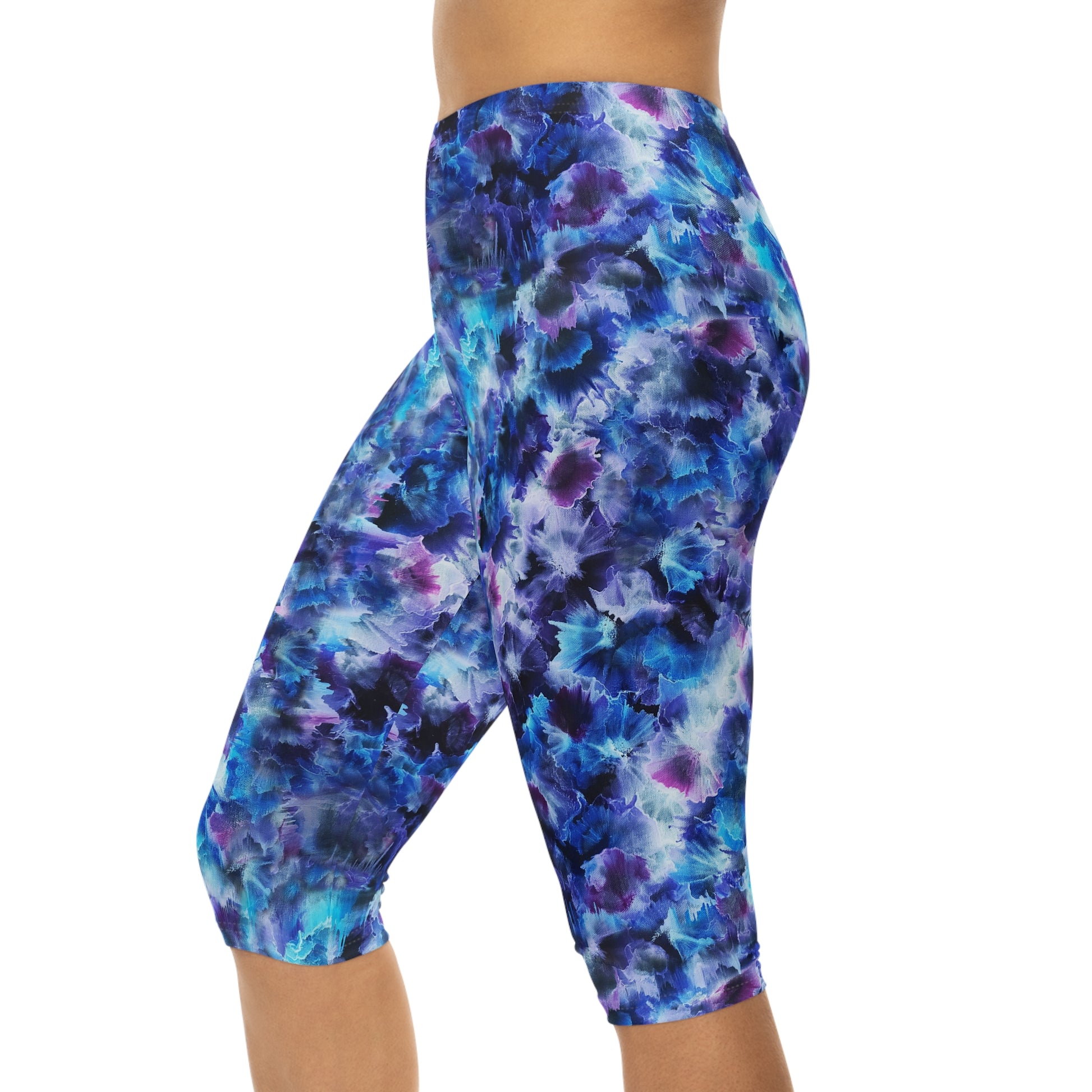 Side view of Cosmos Capri Leggings – Comfortable, stylish activewear featuring a vibrant starry design in blue and purple hues.