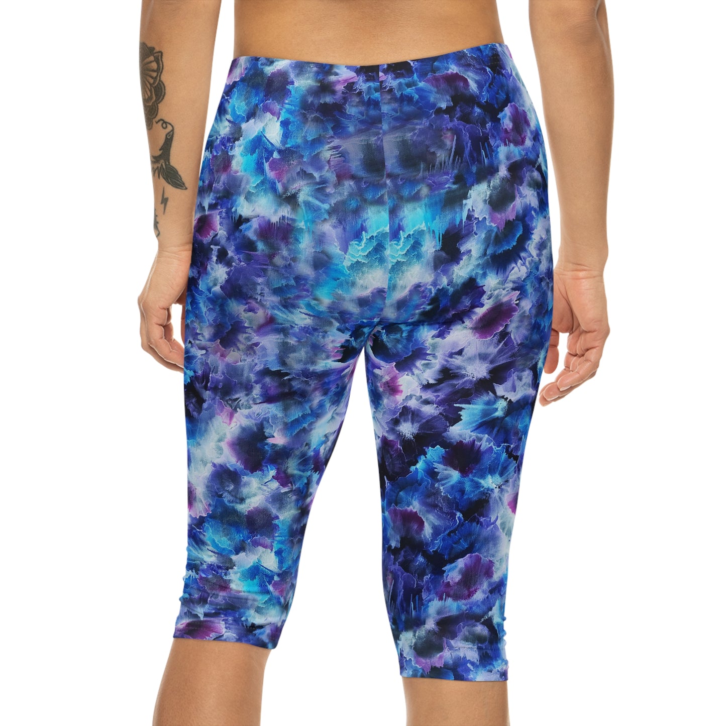 Back view of Cosmos Capri Leggings – Comfortable, stylish activewear featuring a vibrant dreamy design in blue and purple hues.