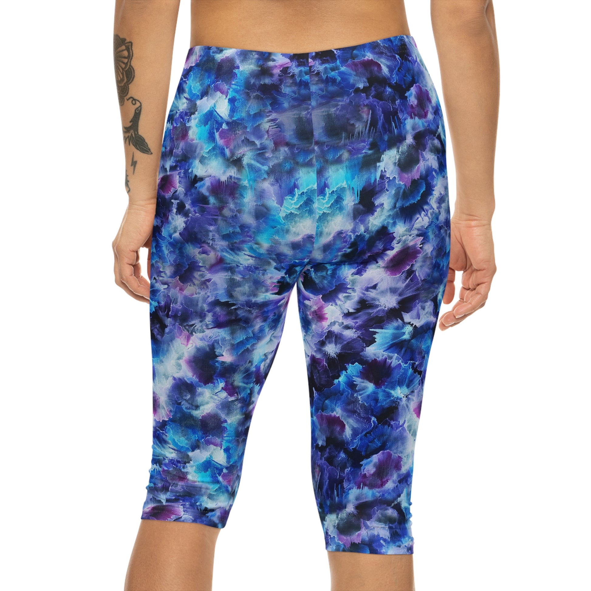 Back view of Cosmos Capri Leggings – Comfortable, stylish activewear featuring a vibrant dreamy design in blue and purple hues.