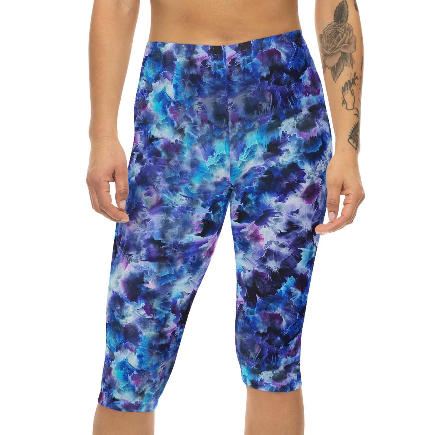 Front view of Cosmos Capri Leggings: They have a dreamy pattern with blue, purple, and black accents, perfect for fitness or casual wear.