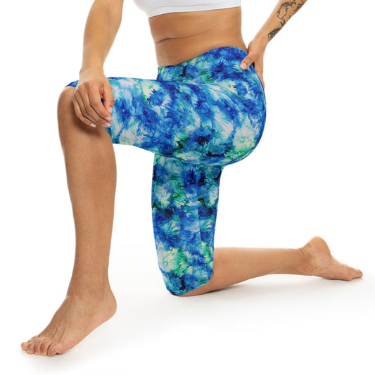 Ocean Mist Capri Leggings by Alisa Marie, featuring the Coastal Blue pattern, are shown in action during yoga practice.