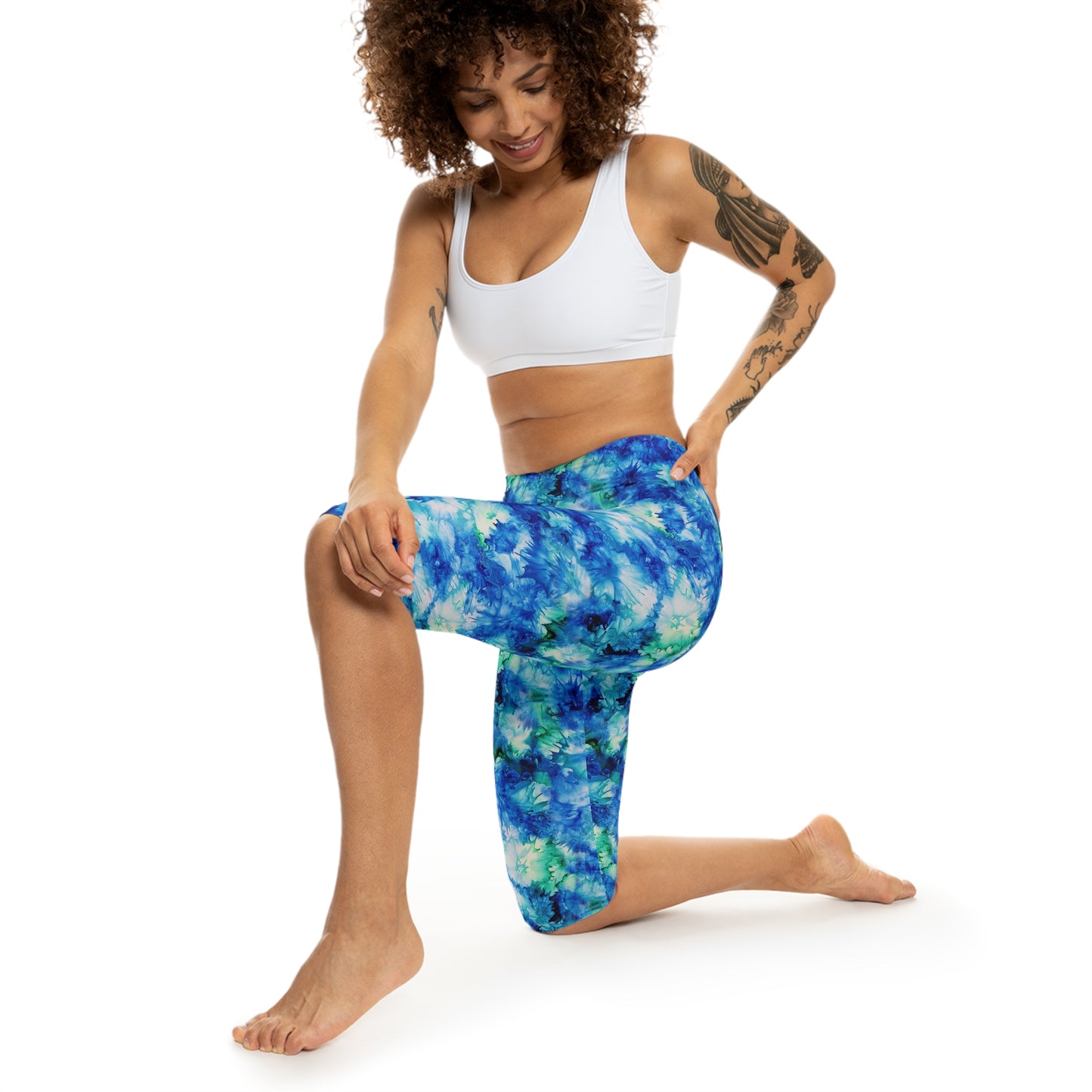 The model is wearing Ocean Mist Capri Leggings by Alisa Marie. The Coastal Blue design is perfect for yoga, fitness, or casual outings.