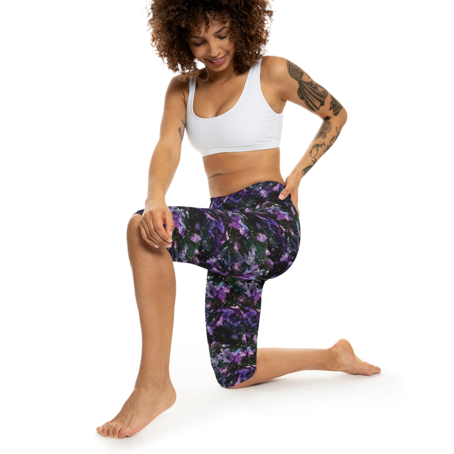 Action view of model wearing Purple Storm Capri Leggings by Alisa Marie. Bold galaxy purple and black design, ideal for yoga, fitness, or casual wear.