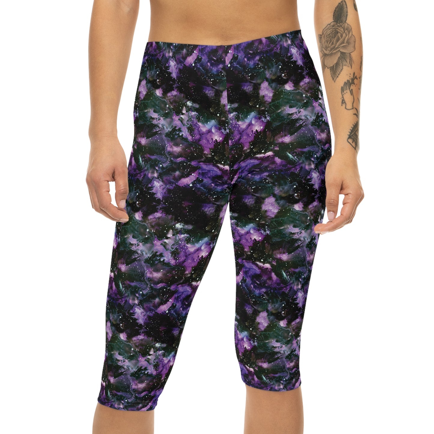 Front view of model wearing Purple Storm Capri Leggings by Alisa Marie. Bold galaxy purple and black design, ideal for yoga, fitness, or casual wear.