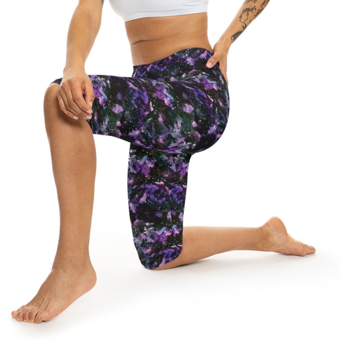 Model wearing Purple Storm Capri Leggings by Alisa Marie. Bold galaxy purple and black design, ideal for yoga, fitness, or casual wear.