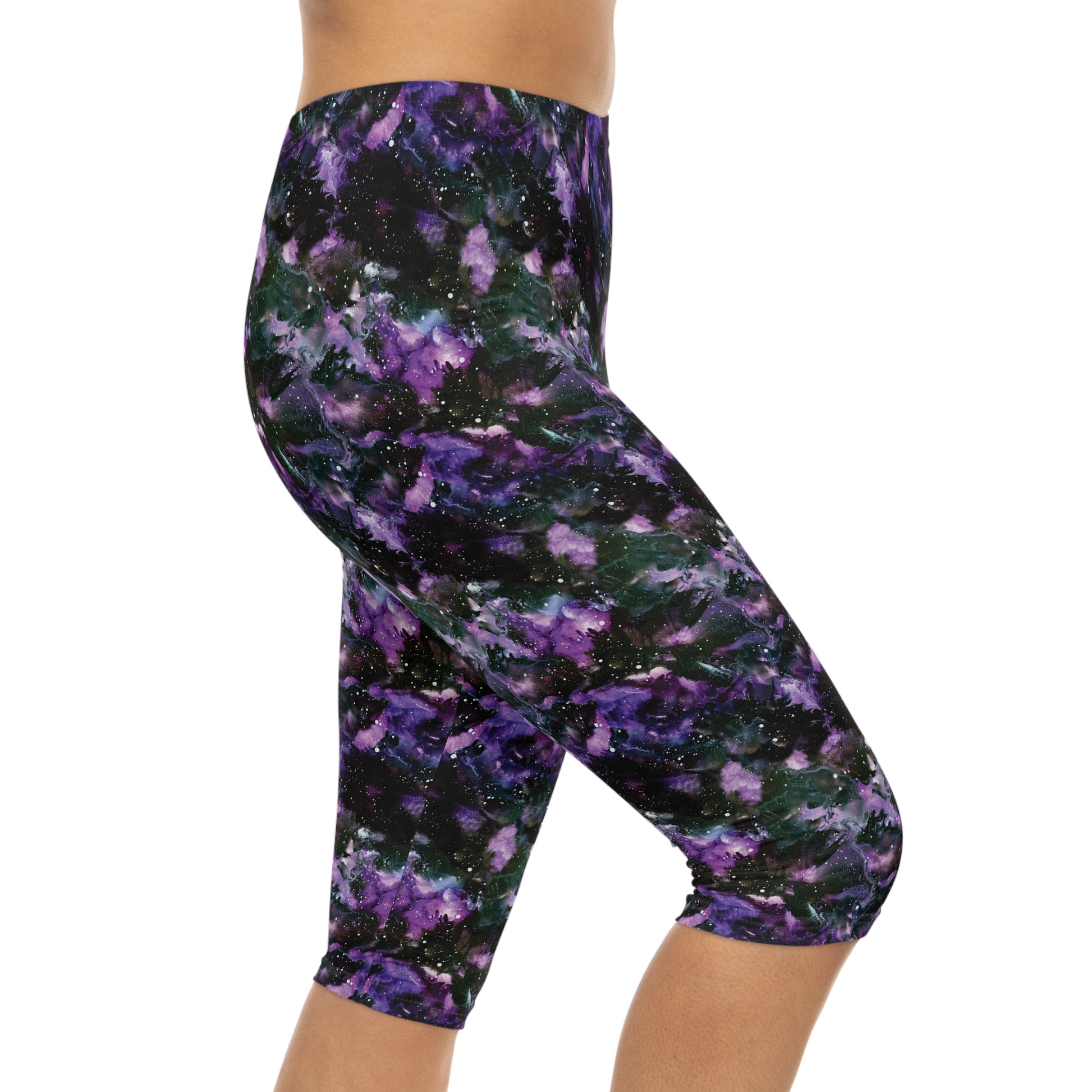 Right side view of model wearing Purple Storm Capri Leggings by Alisa Marie. Bold galaxy purple and black design, ideal for yoga, fitness, or casual wear.