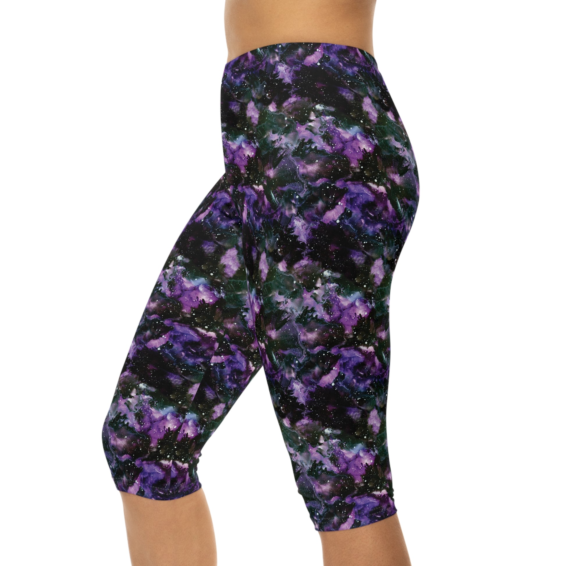 Side view of model wearing Purple Storm Capri Leggings by Alisa Marie. Bold galaxy purple and black design, ideal for yoga, fitness, or casual wear.