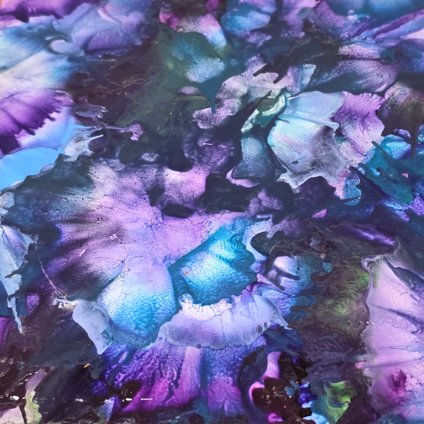 Abstract art with a mix of purple, blue, and green colors.