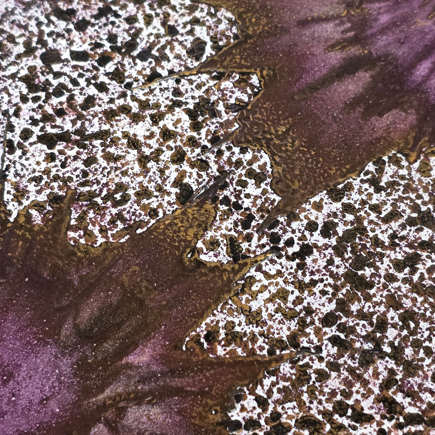 Close-up of textured purple and brown surface with white speckles