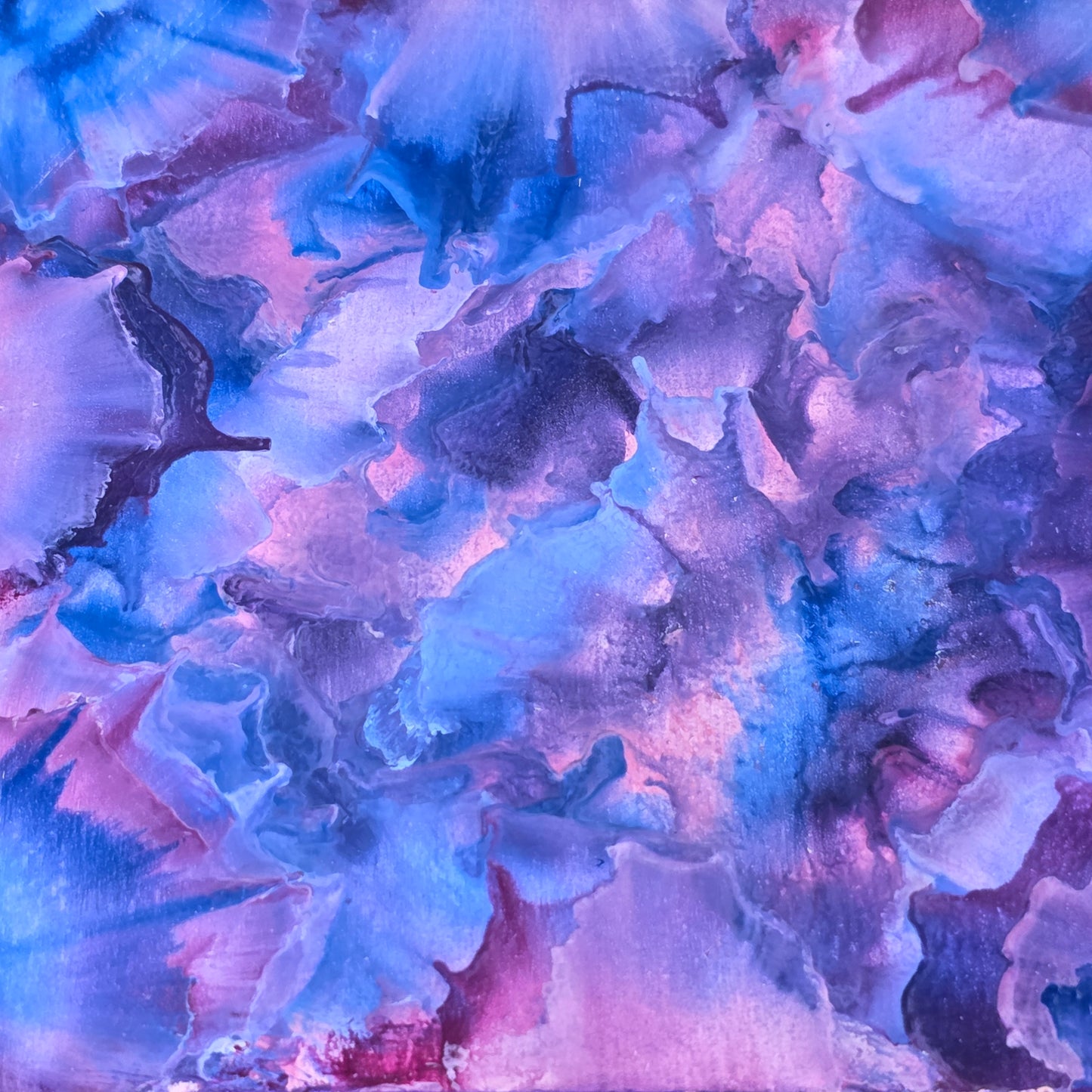 Abstract artwork with swirling blue and pink colors
