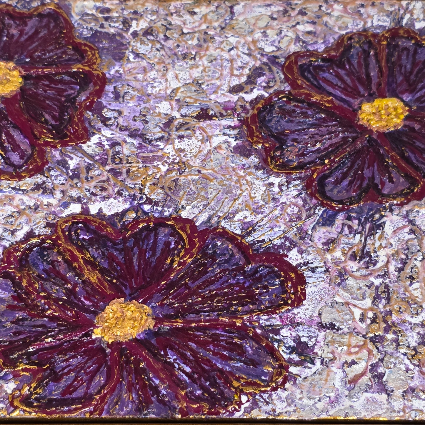 Close-up of purple flowers with gold centers on a textured background