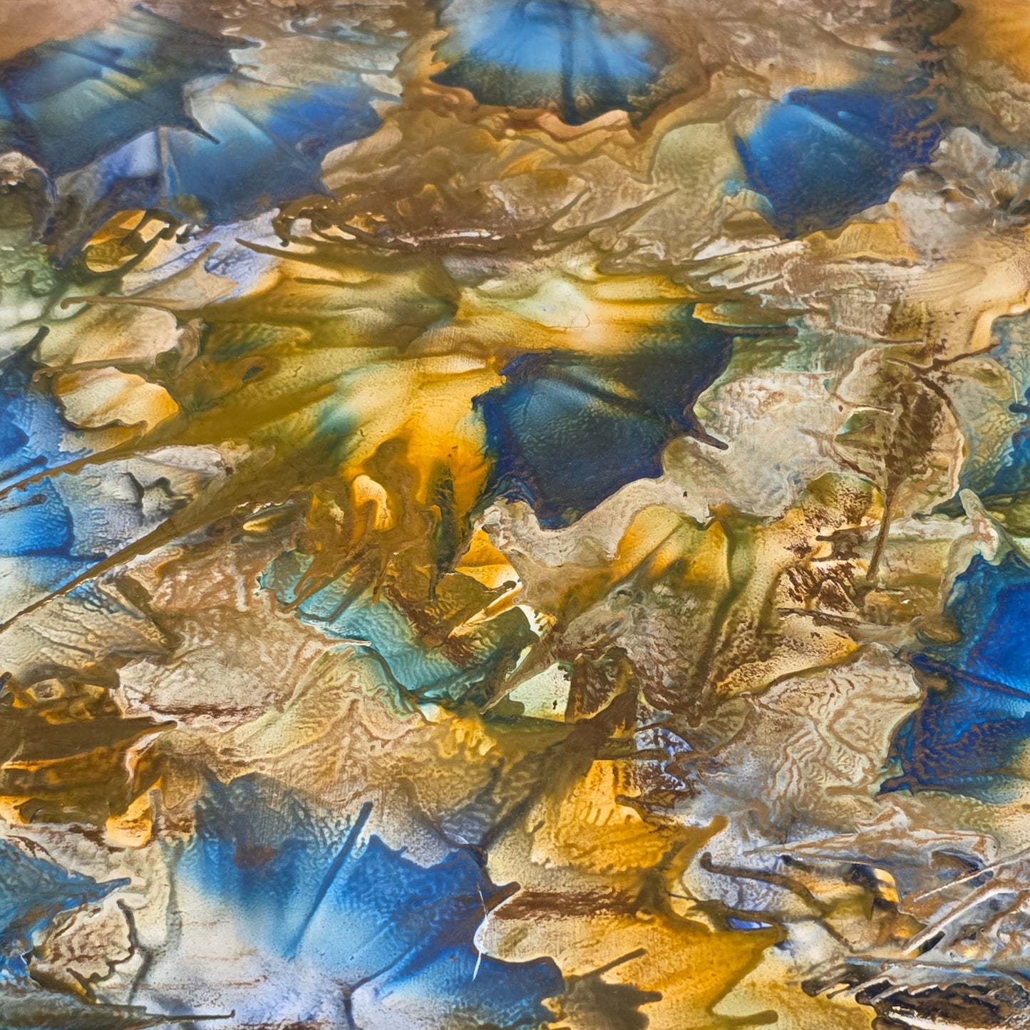 Abstract art with blue, gold, and brown colors