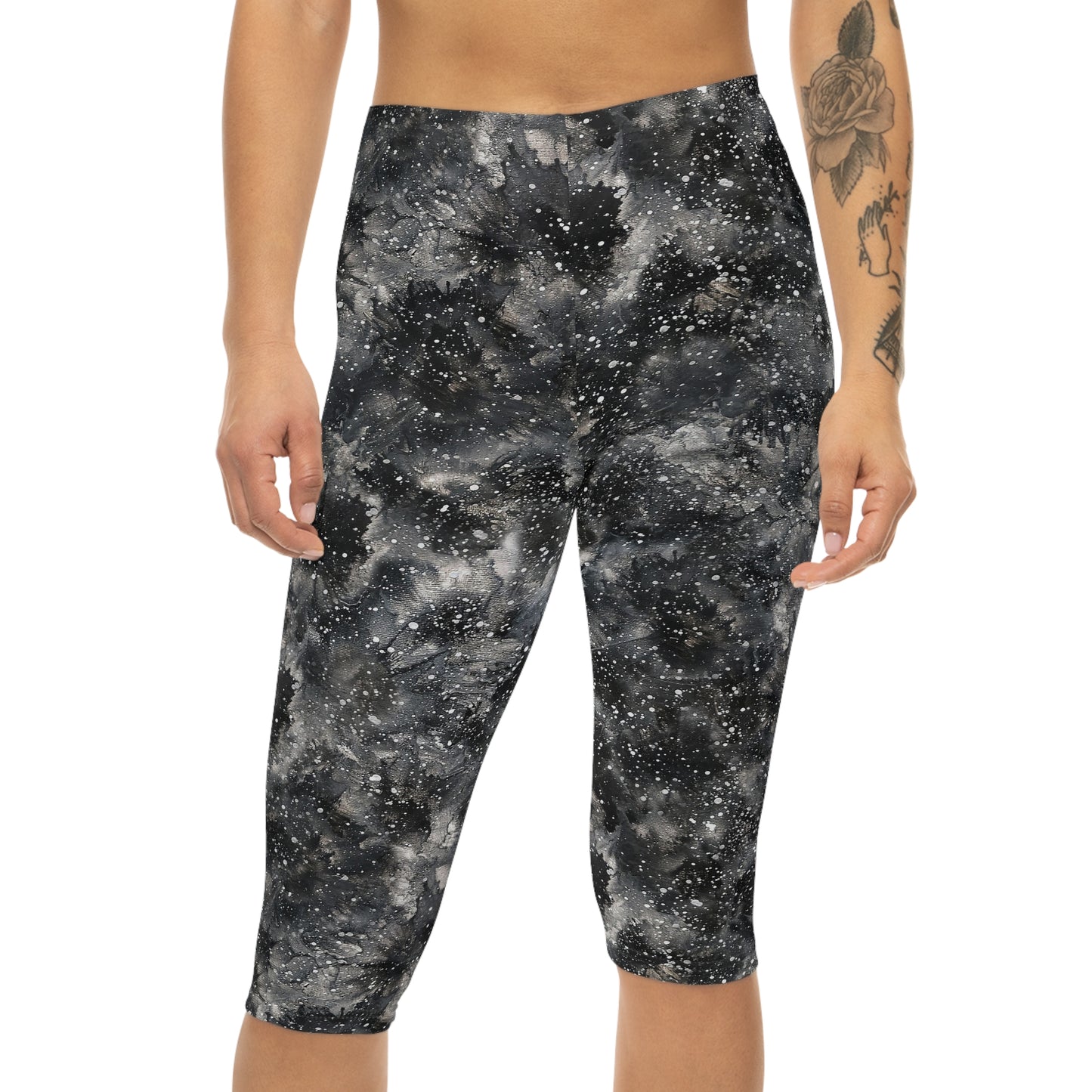 The model is wearing Starry Night Capri Leggings by Alisa Marie. Galaxy-inspired design, perfect for yoga, fitness, and casual wear with vibrant colors.
