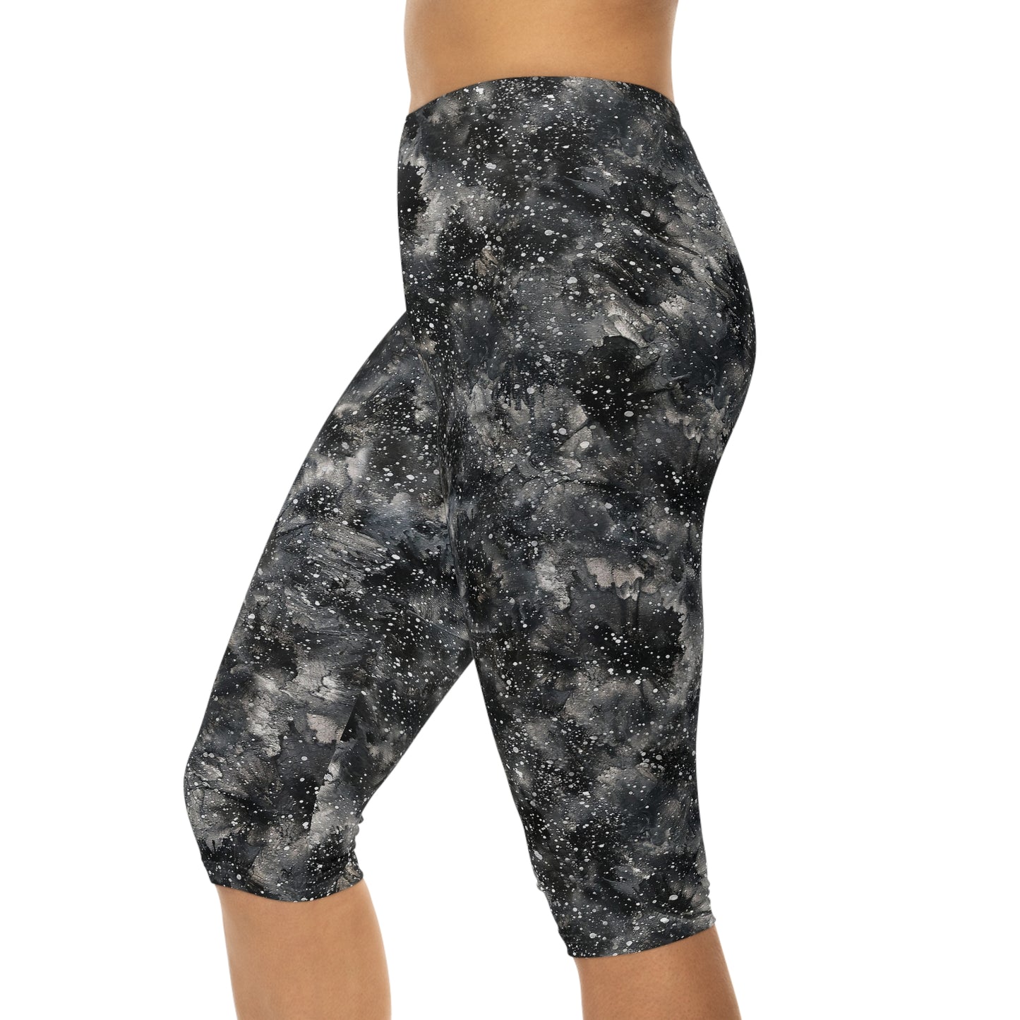 The model is wearing Starry Night Capri Leggings by Alisa Marie. Galaxy-inspired design, perfect for yoga, fitness, and casual wear with vibrant colors.
