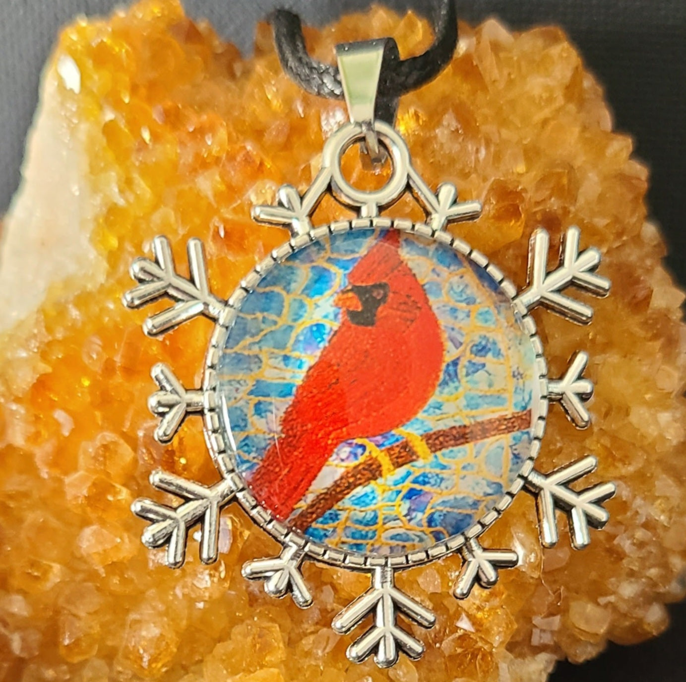 Alisa Marie original artwork, Always Beside You, Cardinal Memorial Pendant featuring a red cardinal bird set within a silver snowflake design on turquoise background, displayed on citrine crystal.