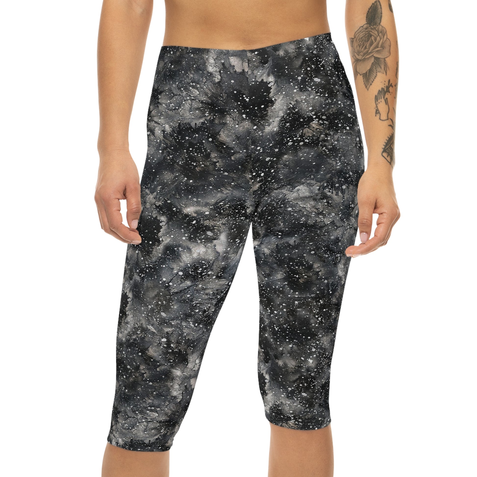 The model is wearing Starry Night Capri Leggings by Alisa Marie. Galaxy-inspired design, perfect for yoga, fitness, and casual wear with vibrant colors.