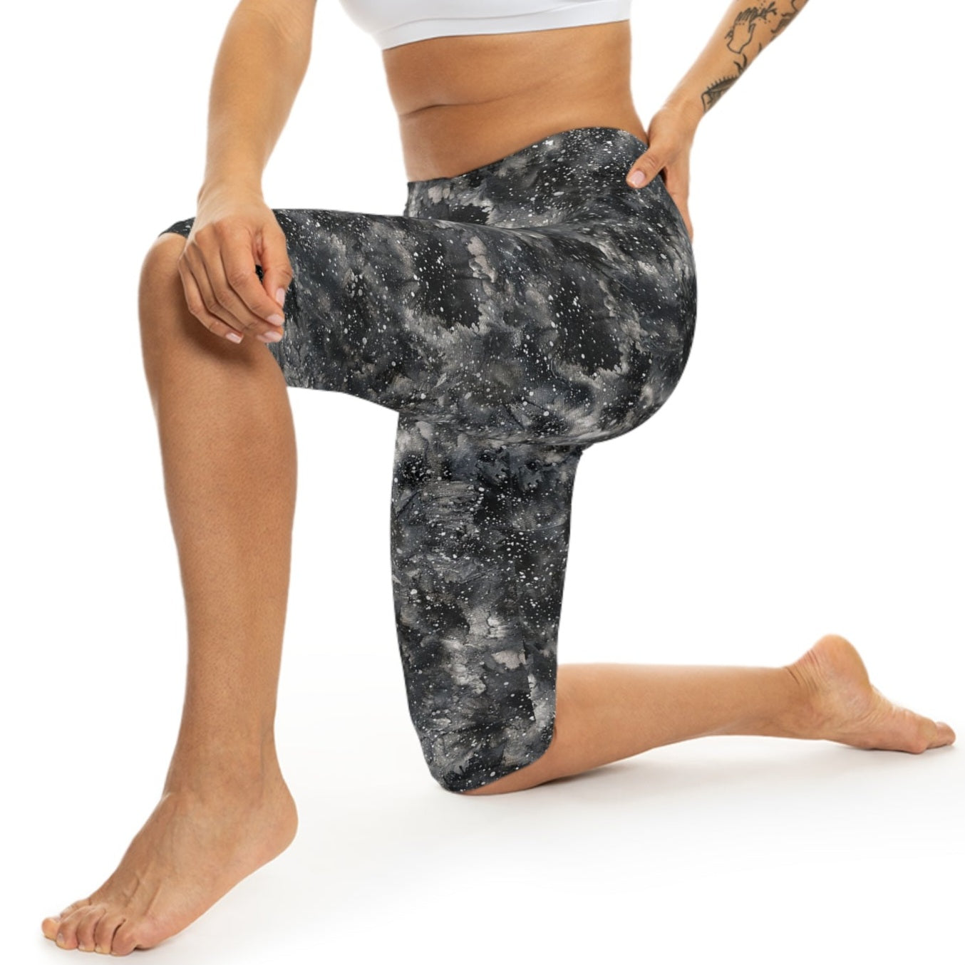 The model is wearing Starry Night Capri Leggings by Alisa Marie. Galaxy-inspired design, perfect for yoga, fitness, and casual wear with vibrant colors.