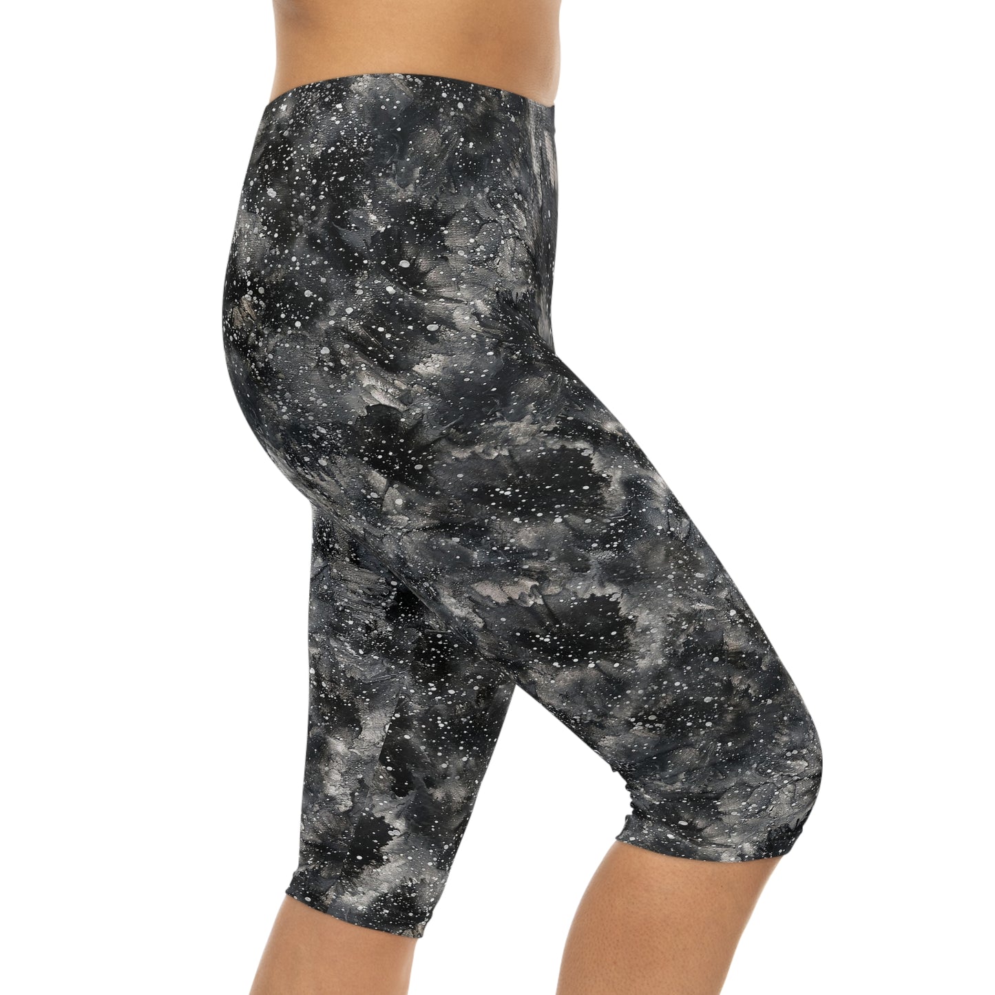 The model is wearing Starry Night Capri Leggings by Alisa Marie. Galaxy-inspired design, perfect for yoga, fitness, and casual wear with vibrant colors.